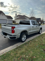 Silver 2019 Chevrolet Silverado 1500 parked on a residential street, showcasing sleek design and clean exterior.