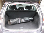 Spacious trunk of a 2012 Subaru Outback 2.5i AWD displaying a rolled-up item