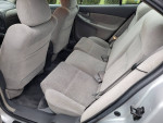 Interior view of a 2003 Oldsmobile Alero showing spacious back seats and grey cloth upholstery.