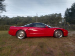 1996 Acura NSX T in red with Type R modifications parked on grass