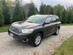 2010 Toyota Highlander SE FWD in good condition with minimal exterior wear, parked on a gravel driveway.