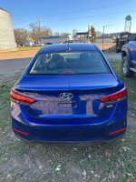 Rear view of a blue 2019 Hyundai Accent SE, showcasing its sleek design and clean title for sale.