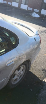 2008 Ford Taurus SEL silver sedan parked with new tires and clean exterior, suitable for winter driving.