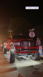 2006 Dodge Ram 2500 mega cab with custom wheels parked at night near Geno's Steaks.