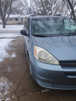 BraunAbility side entry van with handicapped ramp parked on snowy driveway, suitable for wheelchair access.