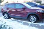 2019 Hyundai Tucson SE FWD parked on snowy driveway, showcasing its exterior design and condition.