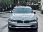 2015 BMW 335 XI AWD in Frozen Silver Metallic with black leather interior, front view on a driveway.