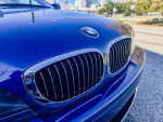 Front view of a restored 2005 BMW e46 330ci Convertible in Mystic Blue Metallic.
