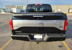Rear view of a 2016 Ford F-150 Platinum 4WD showcasing its sleek design and features.