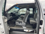 Interior view of a 2002 Ford F250 Plow Truck showing the front and back seats with a clean layout.