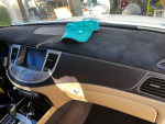Interior dashboard of a 2009 Genesis sedan with navigation and a cap on top.
