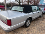 1995 Lincoln Towncar Signature with silver exterior, black convertible top, in excellent condition, ideal for Uber or transportation.