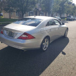 Silver Mercedes-Benz CLS-Class parked on a street, pristine condition with low mileage and new tires.
