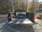 2009 Chevrolet Silverado 1500 Work Truck with aftermarket fifth wheel hitch in a forested area