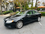 2009 Volvo S80 with 93,000 miles, black exterior and beige interior, parked in a residential area