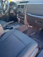 Interior view of a 2012 Jeep Liberty Sport with automatic controls and spacious seating.