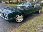 1996 Jaguar XJR in beautiful condition, parked on a grass-lined driveway.