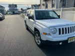 2014 Jeep Patriot SUV parked on the street, reliable and well-maintained with spacious interior.