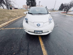 Front view of a 2013 Nissan LEAF SL parked, ideal eco-friendly car for students with spacious interior.