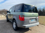Sharp green 2003 Honda Element parked, showcasing clean exterior and garage-kept condition.