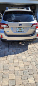 Rear view of a 2017 Subaru Outback 2.5i AWD parked on a paved driveway.