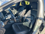 Interior view of a 2015 Mercedes-Benz GLA 250 showing black leather seats and steering wheel.