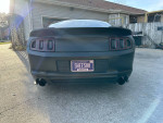 2013 Ford Mustang GT Premium with custom rear design parked in driveway, showcasing a clean matte finish.