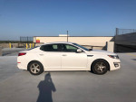 2015 Kia Optima in white parked on a rooftop, featuring new tires and a clean title for sale.