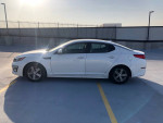 2015 Kia Optima in white parked on pavement, featuring new tires and clean title, good daily driver with no engine lights.