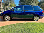 2006 Toyota Sienna LE minivan in blue with leather seats and tinted windows parked on a sunny day