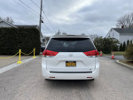 Rear view of a well-maintained 2011 Toyota Sienna LE AWD parked outdoors