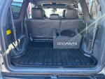 Interior view of the 2003 Lexus GX 470 SUV showing clean trunk space and audio equipment.