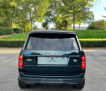 Rear view of a 2019 Land Rover Range Rover Supercharged in rare SVO green color parked outdoors.