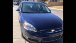 2010 Chevrolet Impala in midnight blue with low mileage and well-kept leather interior for sale.