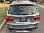 Rear view of a 2014 BMW X3 xDrive28i in remarkable condition, ready for sale.
