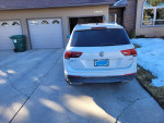 Rear view of a 2018 Volkswagen Tiguan SEL 4Motion AWD in White Silver Metallic parked in a driveway.
