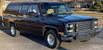 1991 GMC Suburban SLE with low mileage, dark exterior, garage-kept, and well-maintained condition