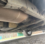 Underbody view of a 2007 Cadillac Escalade showing exhaust and suspension components.