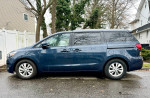 Side view of a 2016 Kia Sedona LX in blue, showcasing its well-maintained exterior and family-friendly design.