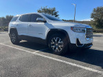 2021 GMC Acadia SLE in white, parked, showing its sleek design and excellent condition.