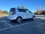 2019 Kia Soul parked in a sunny lot, featuring a white exterior and stylish design.