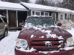 2006 Toyota Tundra Limited front view covered in snow with house background
