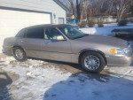 2001 Lincoln Town Car Signature RWD parked in pristine condition, showcasing its elegant design and low mileage.