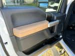 Interior view of 2022 Ford F350 Super Duty door panel showcasing premium materials and features.
