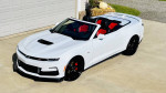 2023 Chevrolet Camaro 2SS Convertible in white with red accents, parked on a driveway.