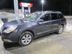 2012 Subaru Outback Limited parked at gas station with 71,000 miles, one owner, well maintained, winter setting.