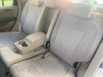 Interior view of 2006 Honda CR-V LX showing clean, comfortable back seats with armrest and cup holder