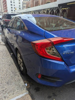 Blue 2016 Honda Civic LX FWD parked on the street, showcasing its compact design and clean condition.