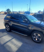 2015 Jeep Cherokee Sport FWD parked with custom features and new tires for sale, showcasing its sleek design.