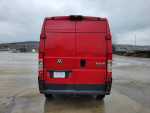 Red 2015 Ram Promaster 2500 high roof van parked, showcasing the rear view and license plate.